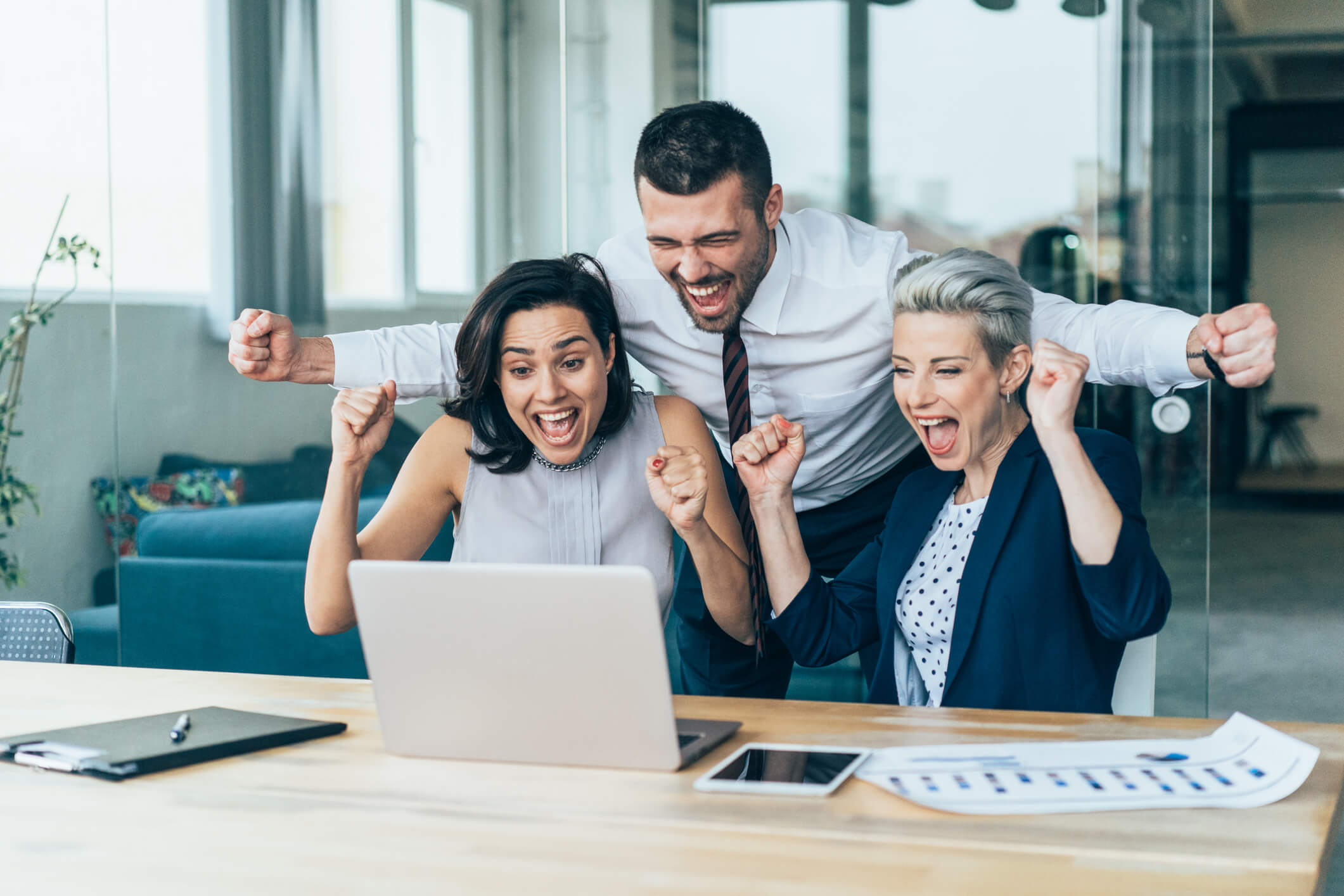 Happy colleagues rejoicing over good news