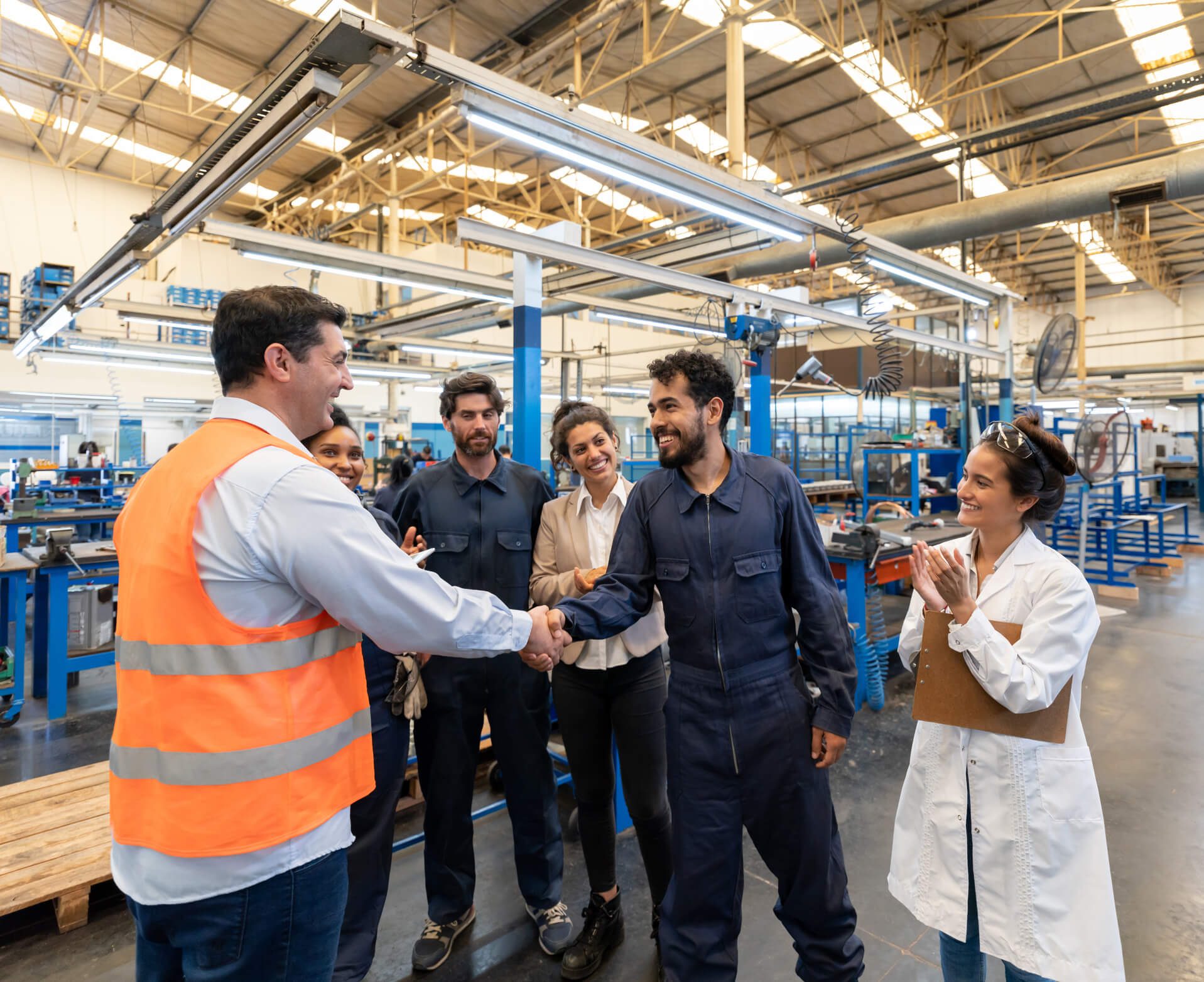 Team celebrating success in industrial setting