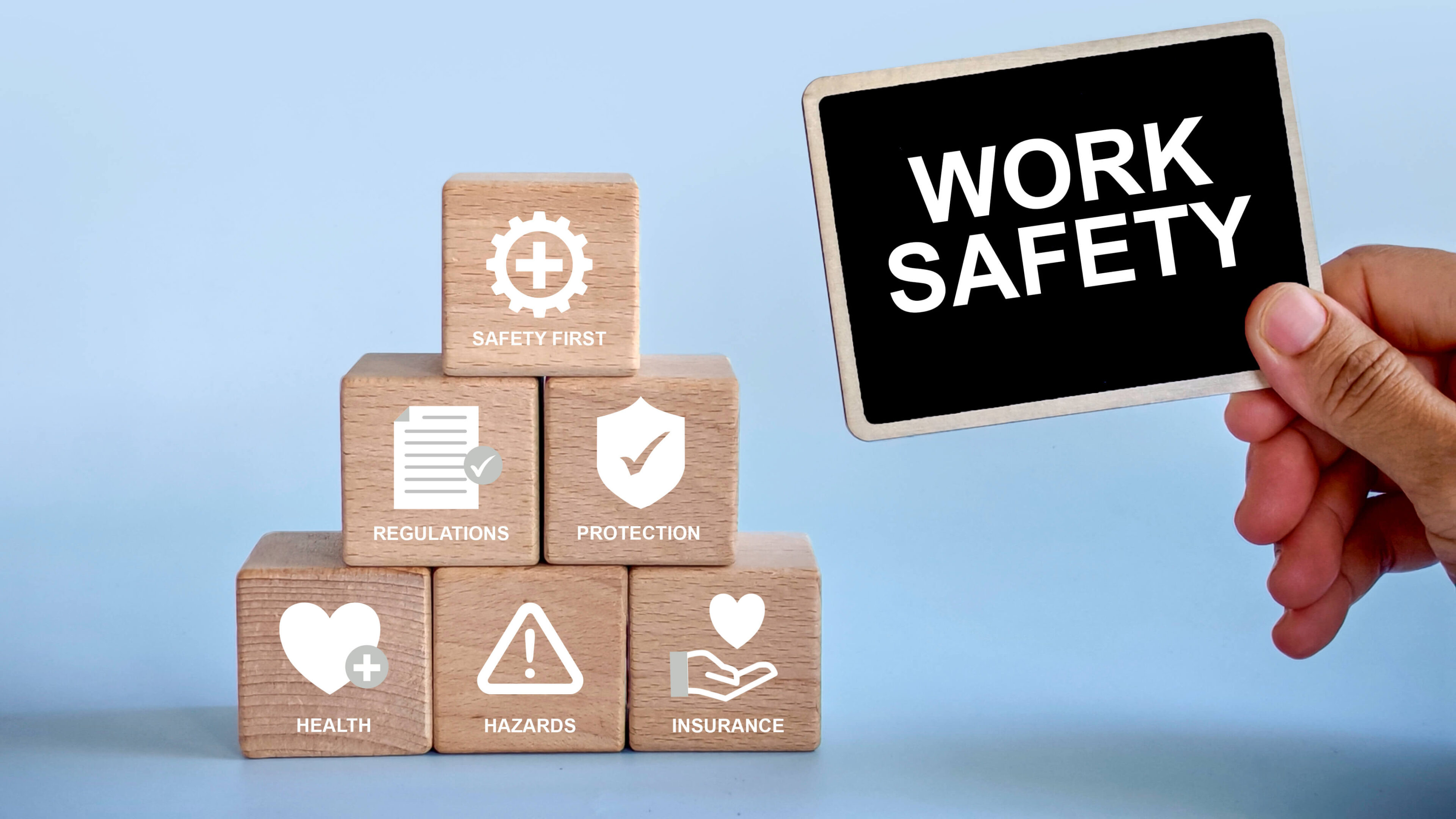 Hand holding work safety board