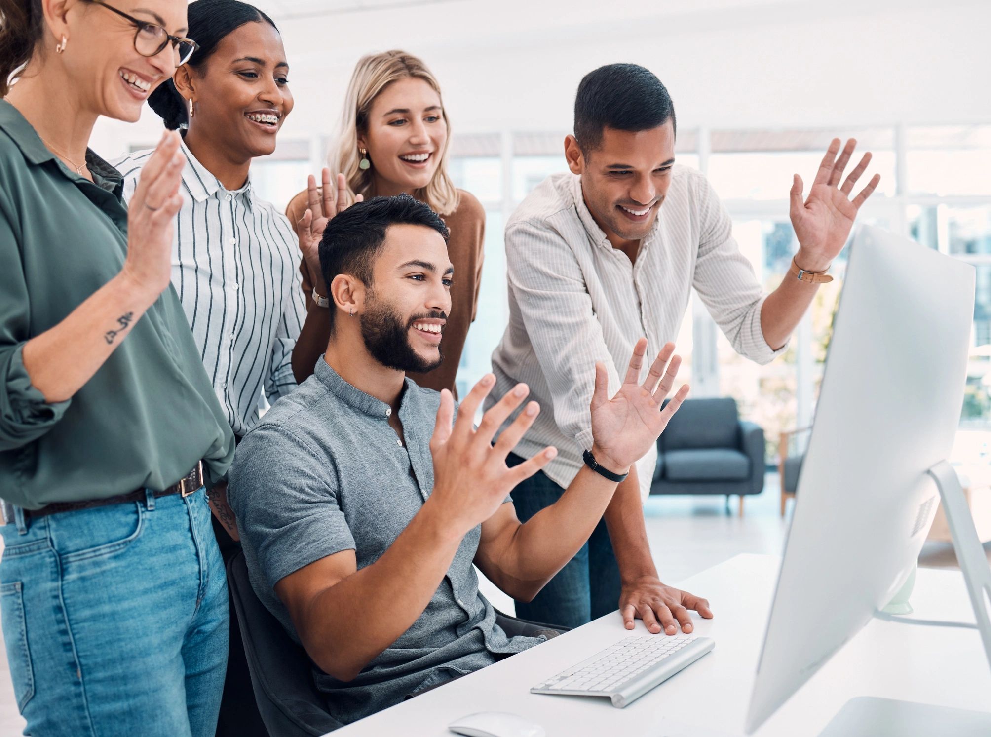 Group cheering at workplace screen